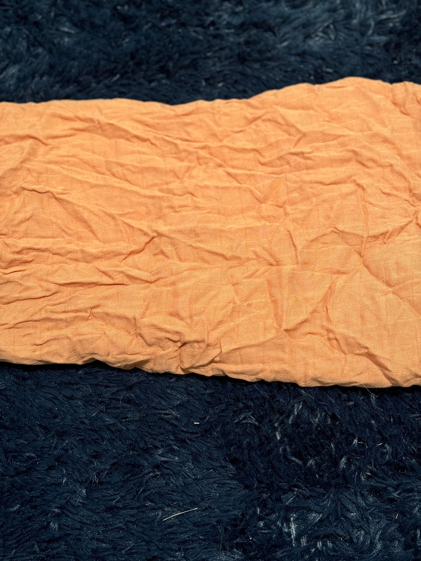 Burnt orange colored light weight blanket
